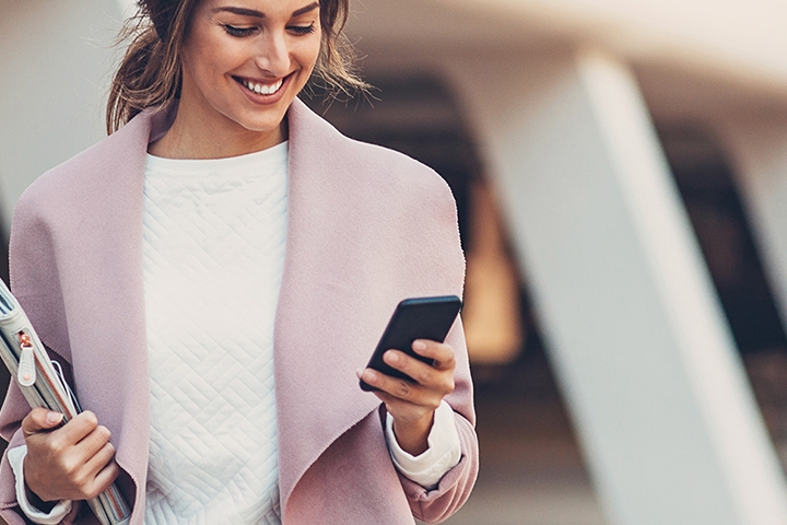 woman smiling at phone