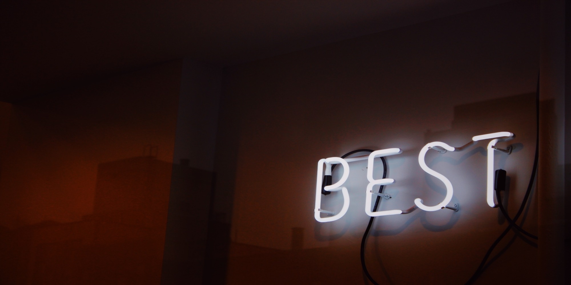 neon sign on a wall that says 'BEST'