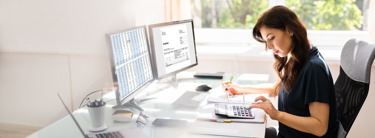 woman working at her desk and doing a financial task