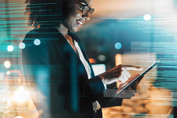 woman using her device with lines of code in the background