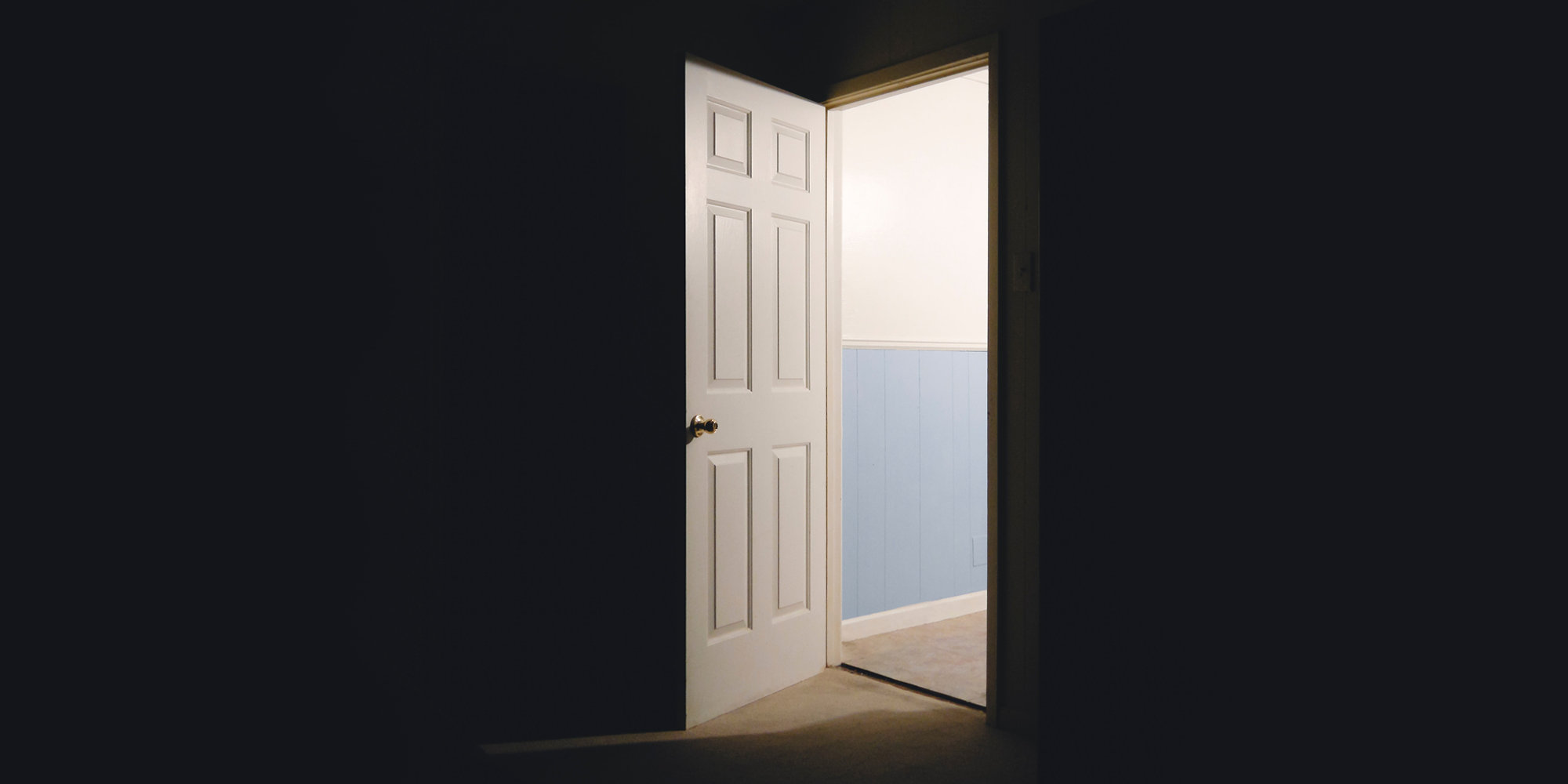 open door into a dark room, view from inside the room