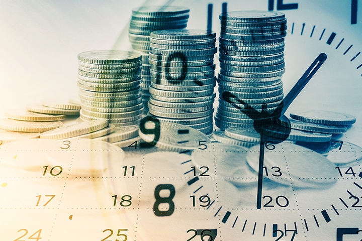 Double exposure shot of rows of coins, a calendar, and an analog clock