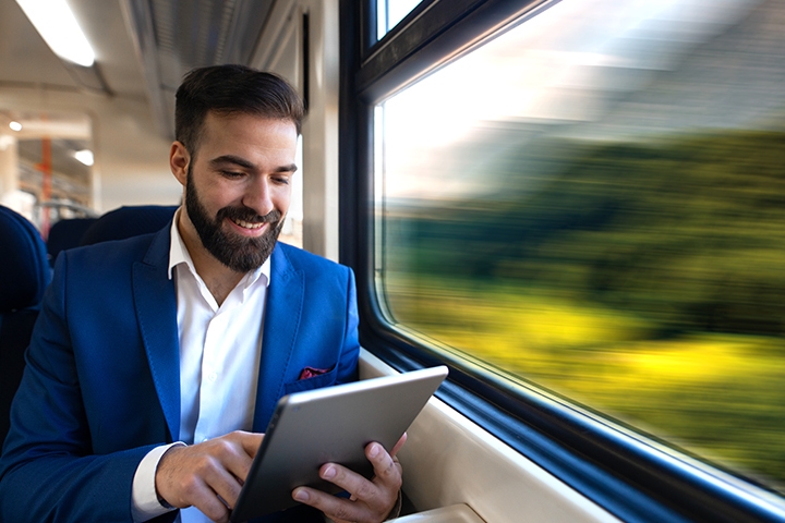 Man using tablet on fast-moving train