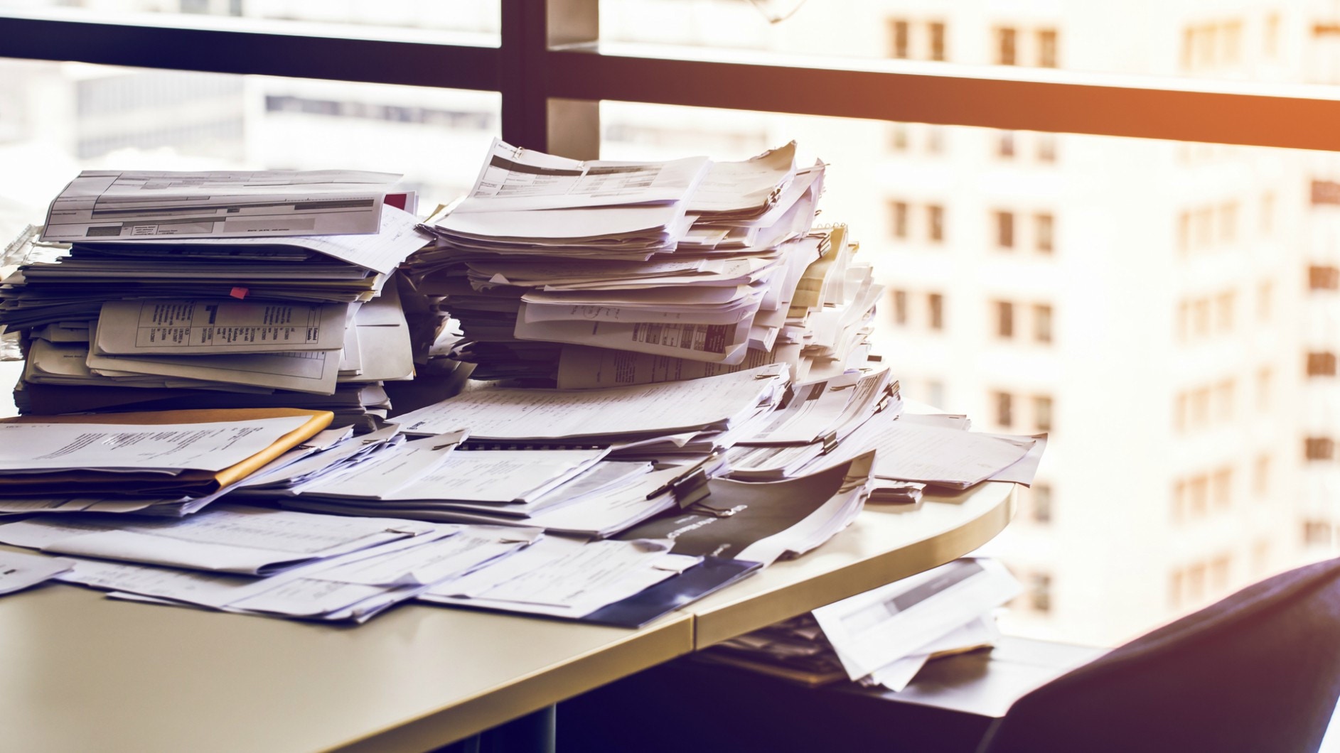 Pile of documents and papers on a desk