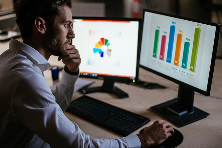 businessman in his office doing research on his computer