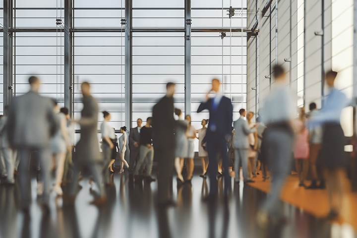 out of focus picture of business people at a convention center