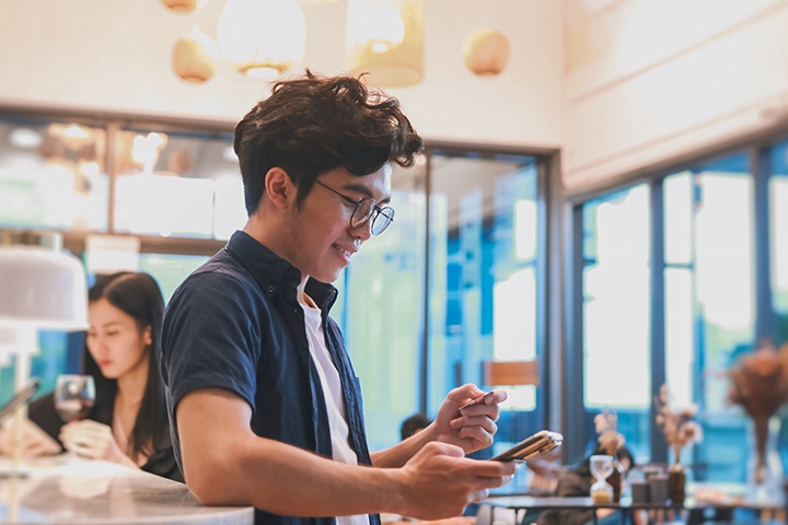 take away customer is paying with contactless payment at coffee shop