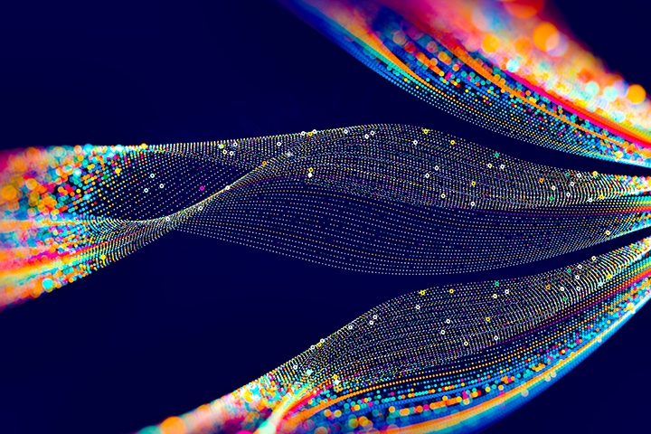 abstract image of ribbons of color dispersing in a dark blue background