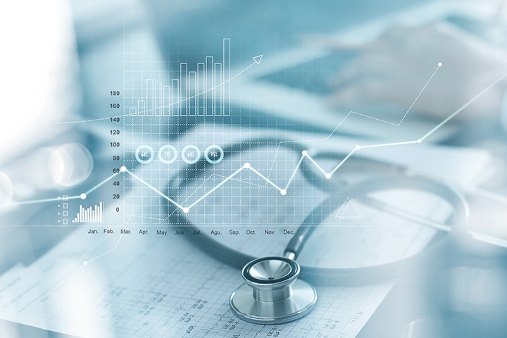 Healthcare business graph; businessman analyzing data and growth chart on blurred background