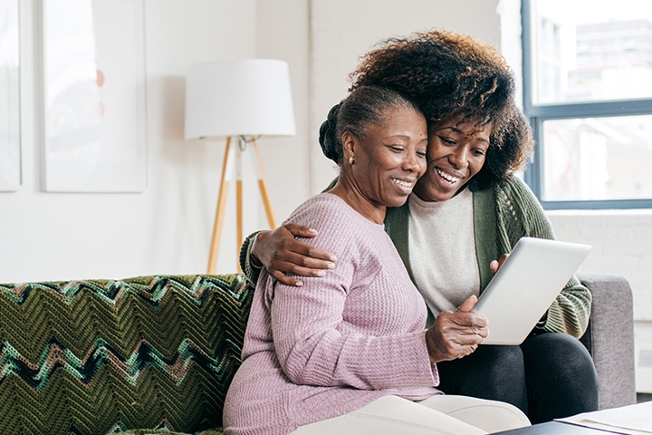 Mother and daughter reading an article on their Smart tablet