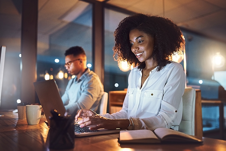 woman working on a laptop at night