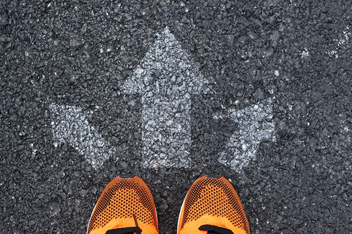 top view of sport shoes on the road with arrows