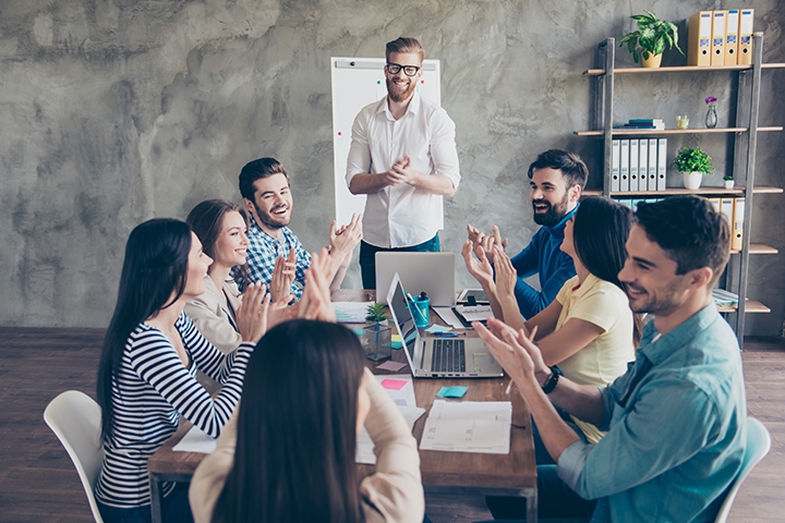 successful business team cheering together in a workspace