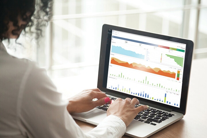 woman conducting data analysis on laptop