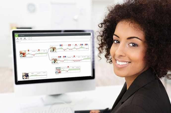 Woman smiling and the computer in background