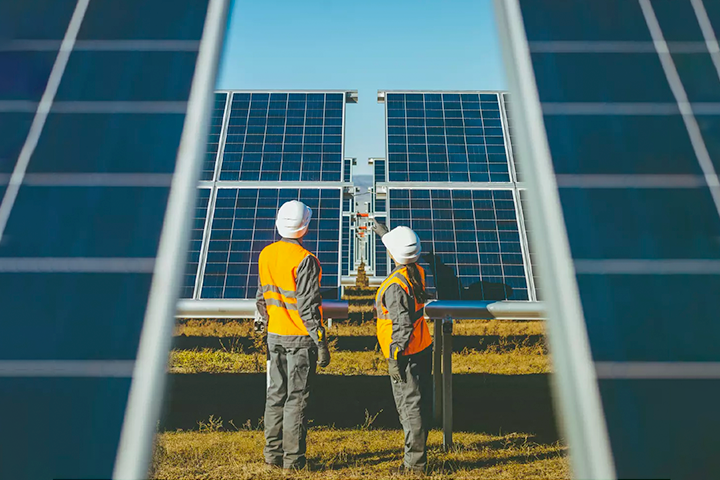 Construction workers inspecting solar pannel