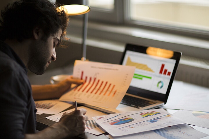 man looking at reports