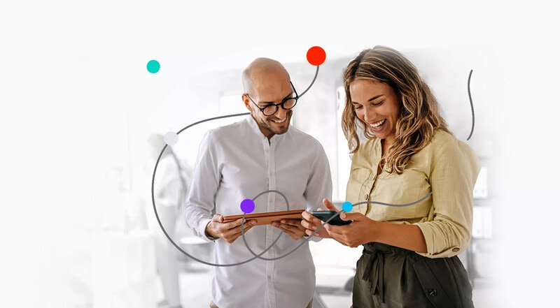 two people holding mobile devices and working together