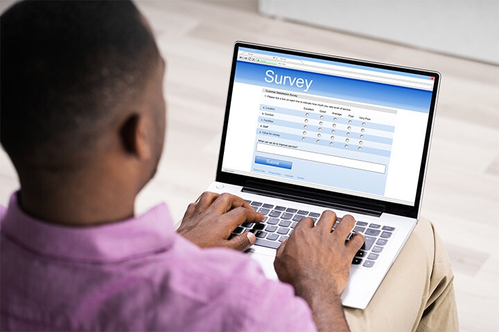 man completing online survey with pre-filled data fields