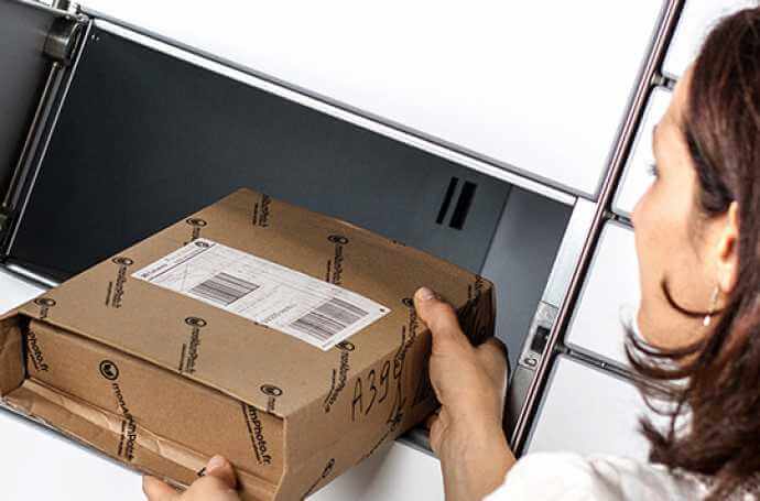 woman collecting a parcel from a parcel locker woman collecting a parcel from a parcel locker