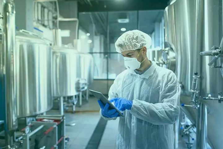 Man in PPE using tablet