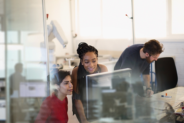 Employees working at hi-tech computer in office