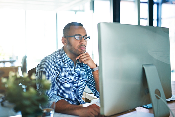 man in office looking at computer screen