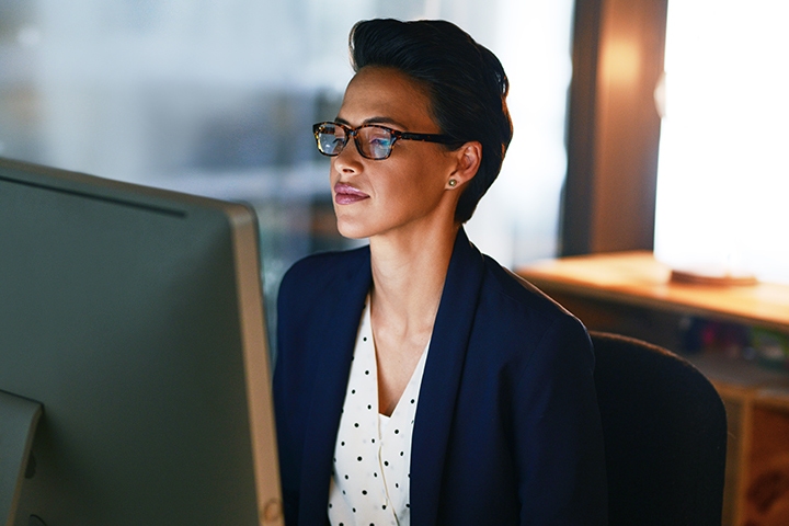 female public service worker in the office looking at computer screen