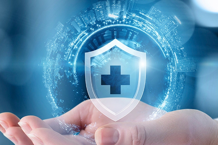 hand holding medical shield with cityscape globe 