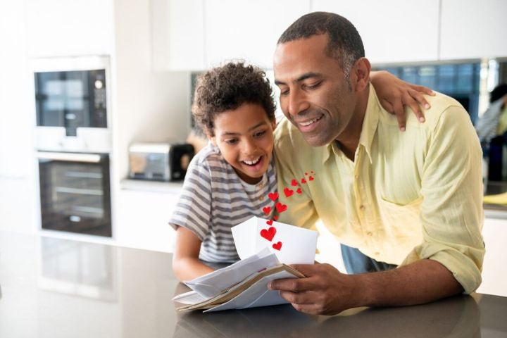 image of a man his son enjoying reading a communication from his supplier