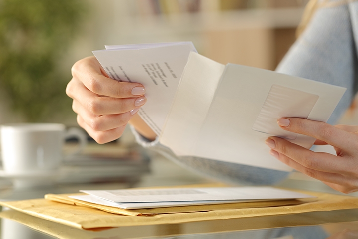 person opening a letter