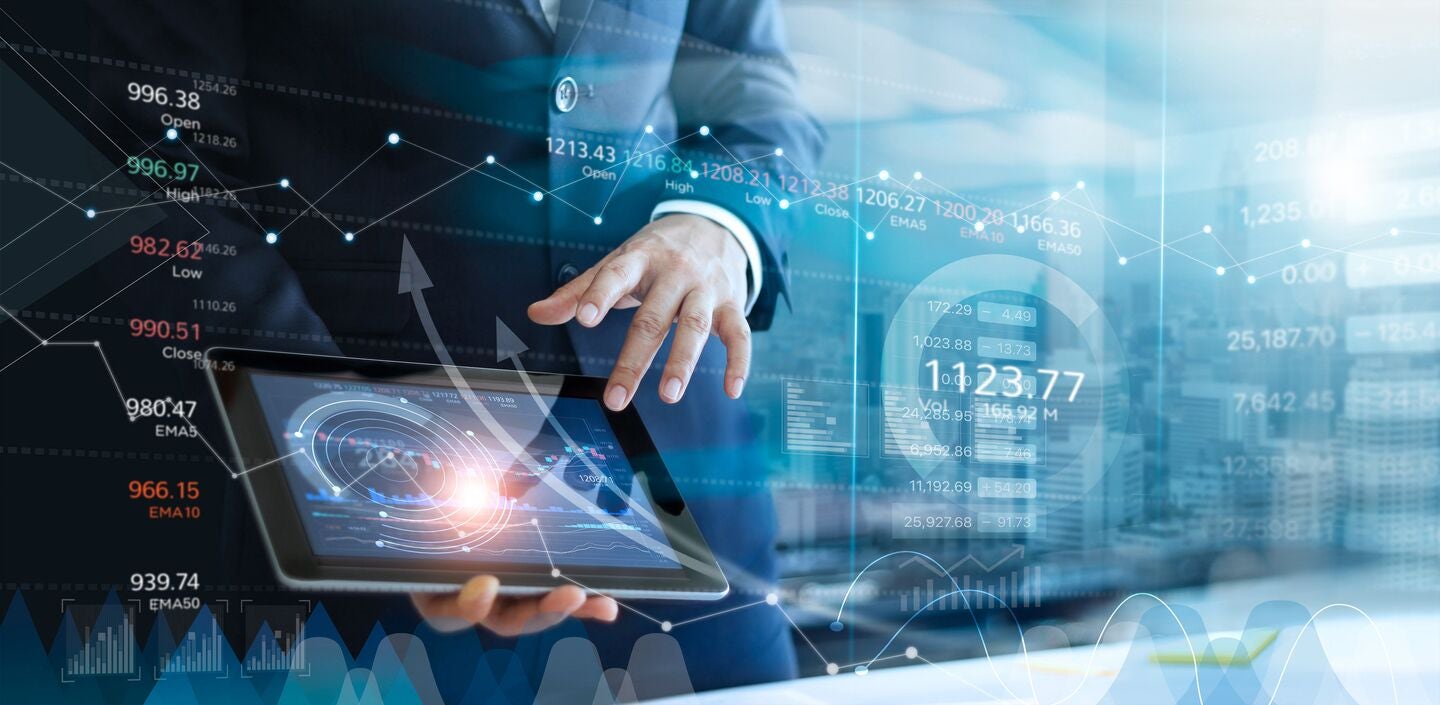 A business professional uses a digital tablet displaying data and analytics, with technology icons layered in the background.