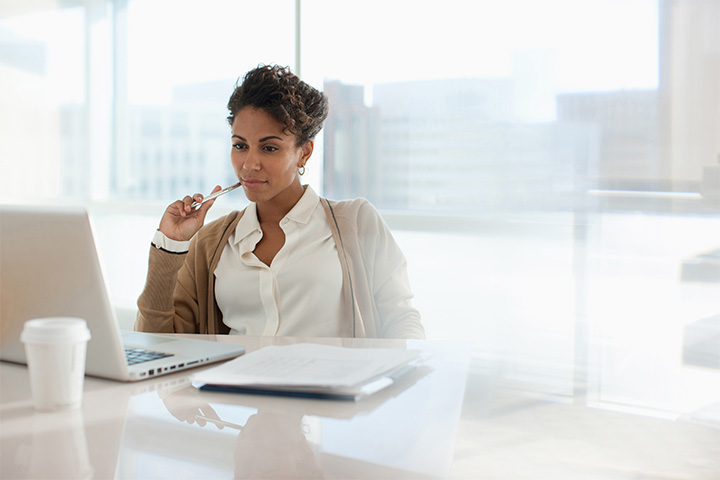 Finance professional reviewing invoices at a desk, illustrating accounts payable processing and financial decision-making.