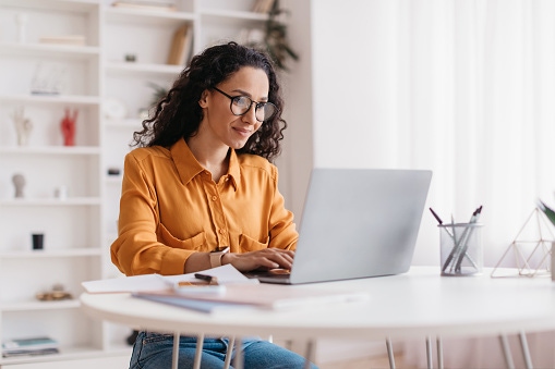 image of woman looking at computer desktop