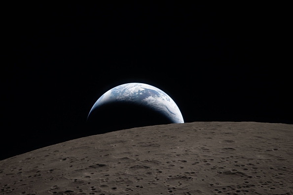 A crescent of Earth is seen from the moon