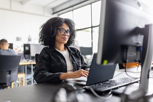 a woman sitting at a computer typing
