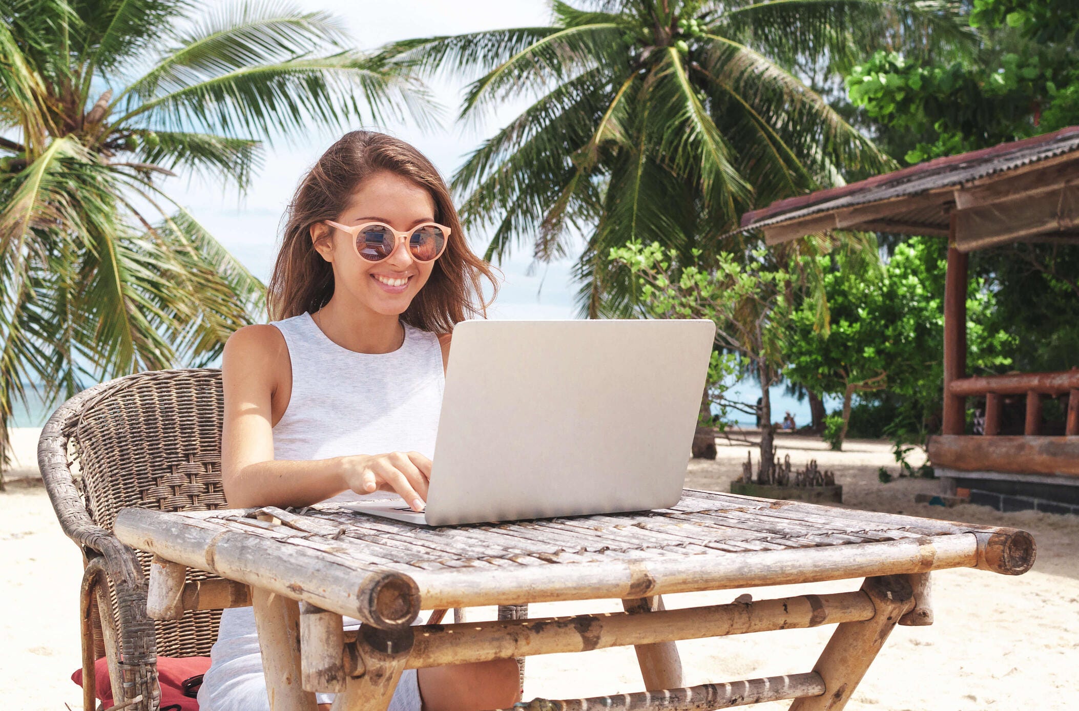 woman working on laptop at a beach