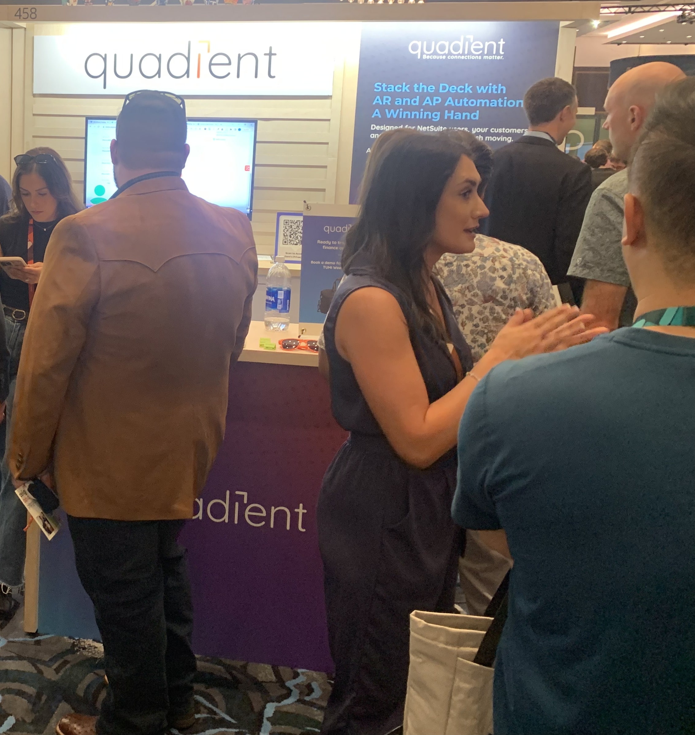 Quadient booth at SuiteWorld2025 showcasing AP and AR automation solutions for NetSuite users, with attendees engaging and viewing product details.